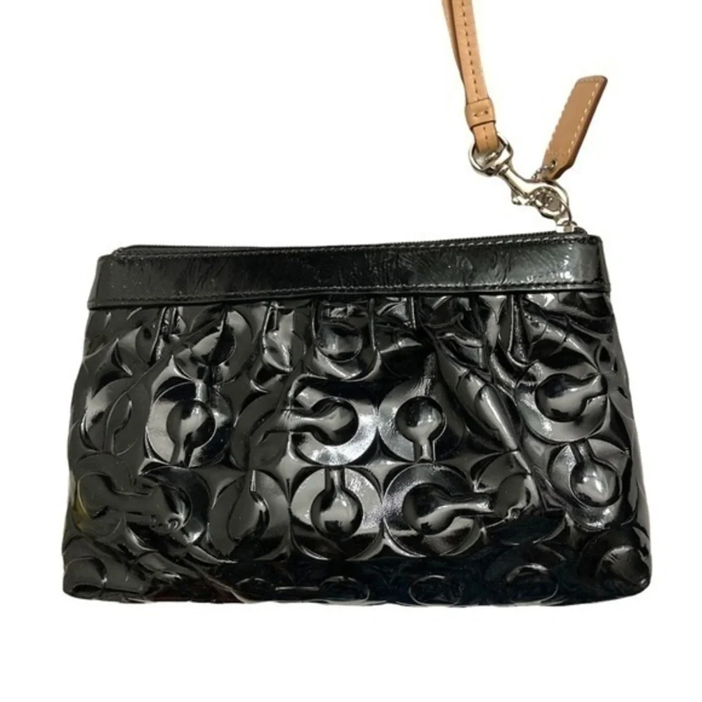 Coach embossed black patent leather op art wristlet bag